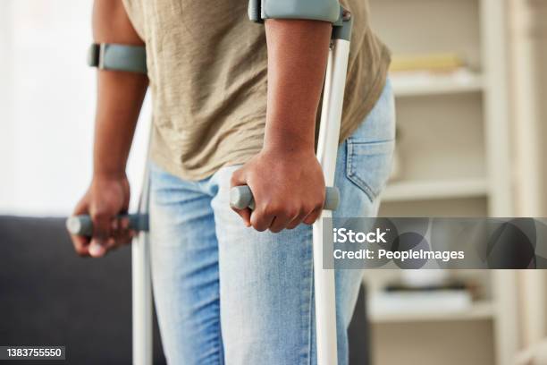 Nurse supporting patient learning to walk